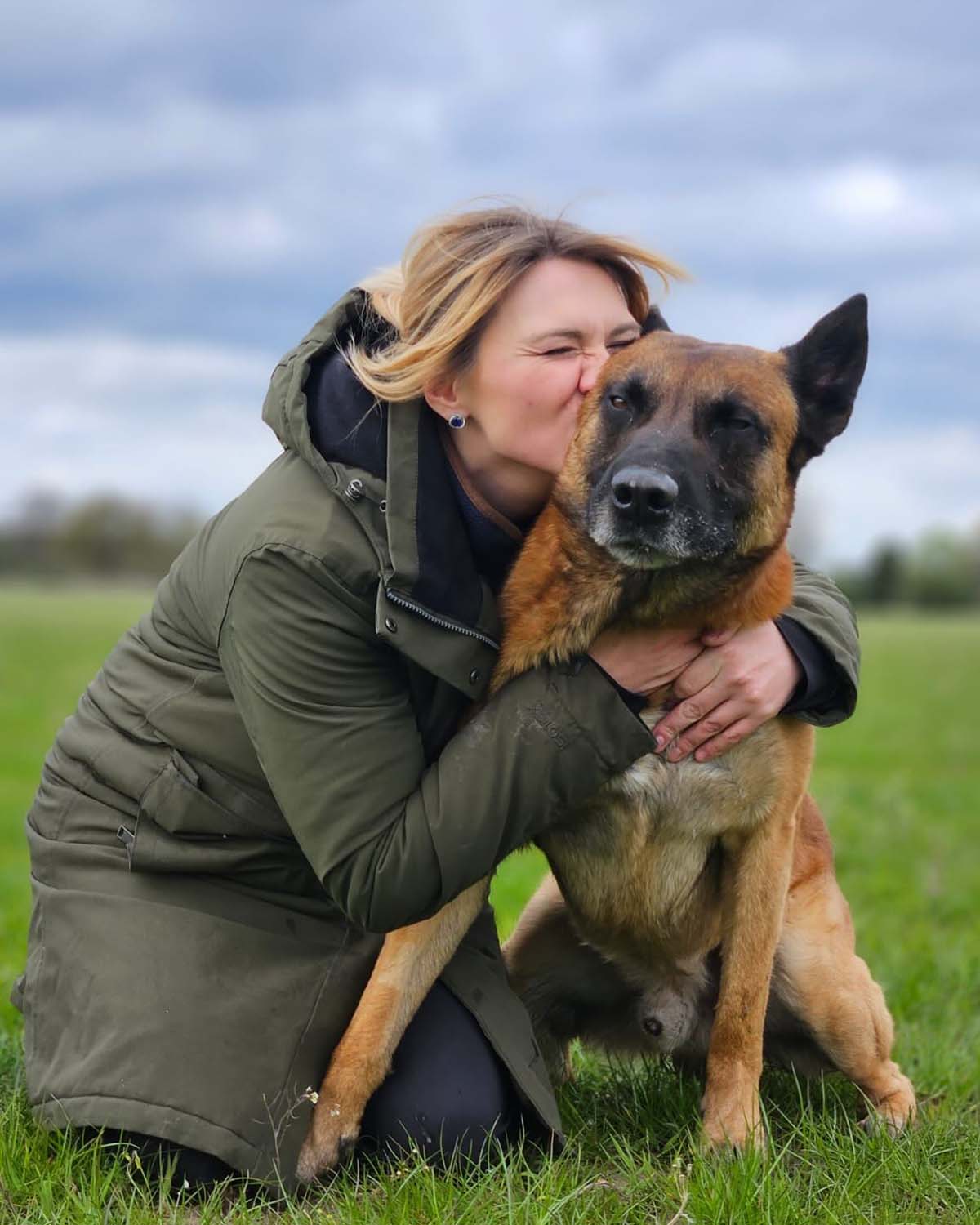 Lydia kissing her dog in Birmingham