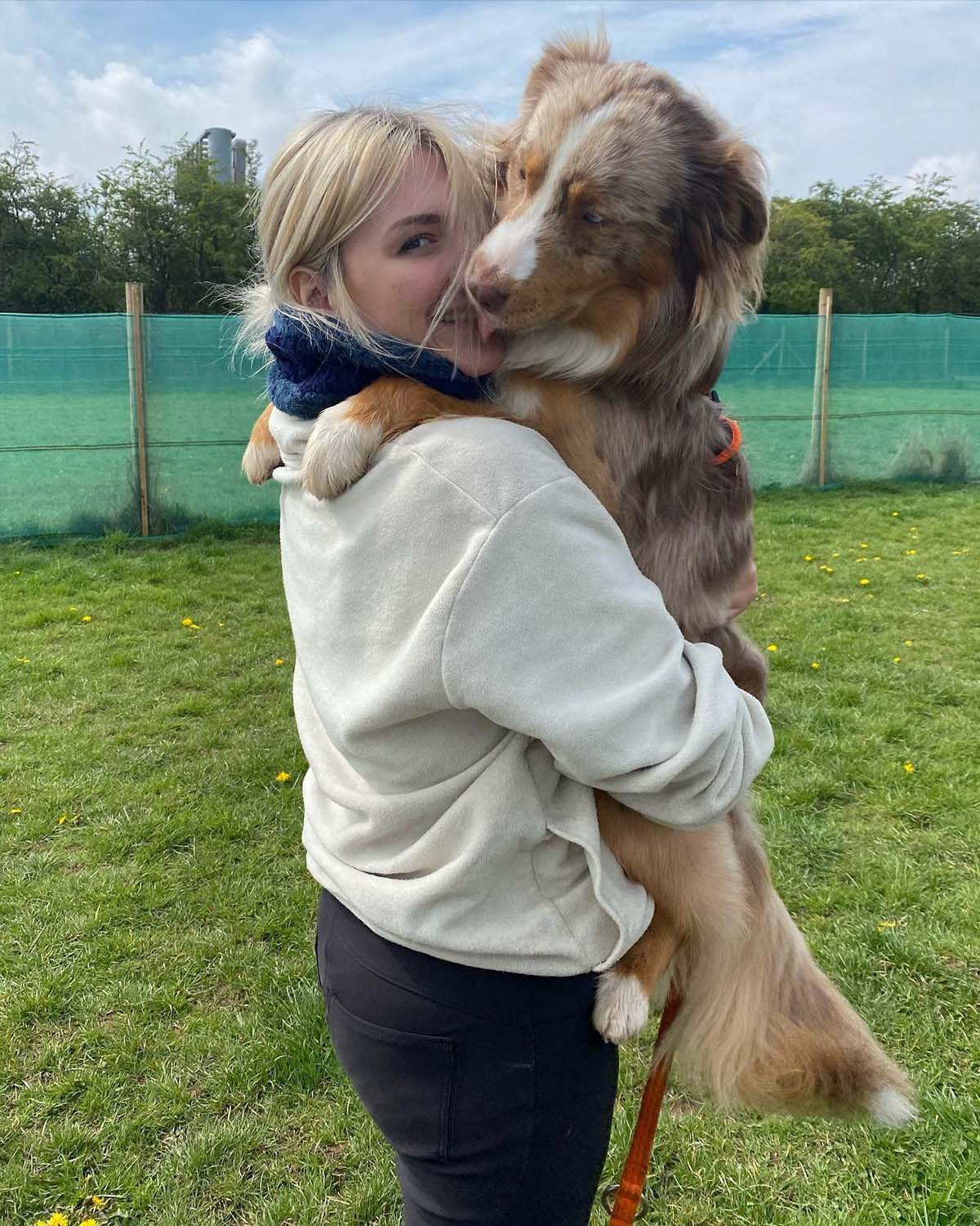 Lydia hugging large fluffy dog in Birmingham